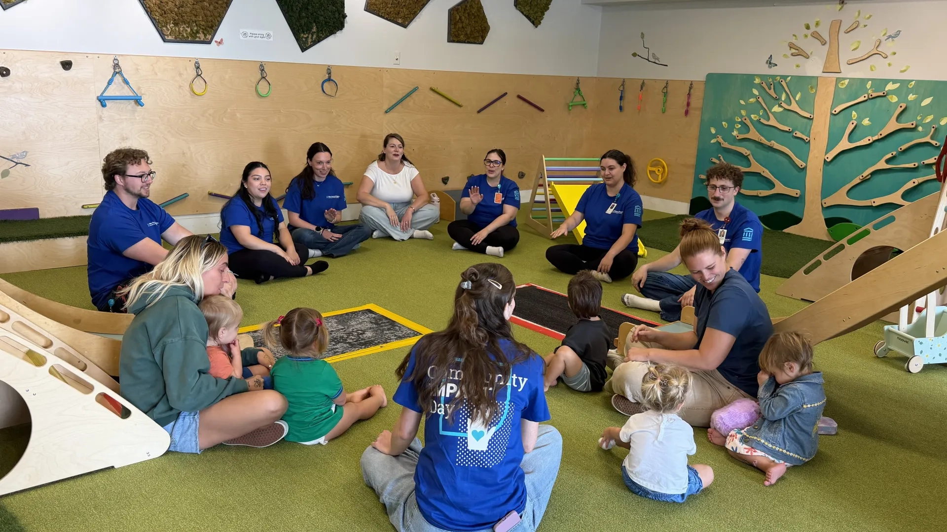 group of people with small children sitting in a circle