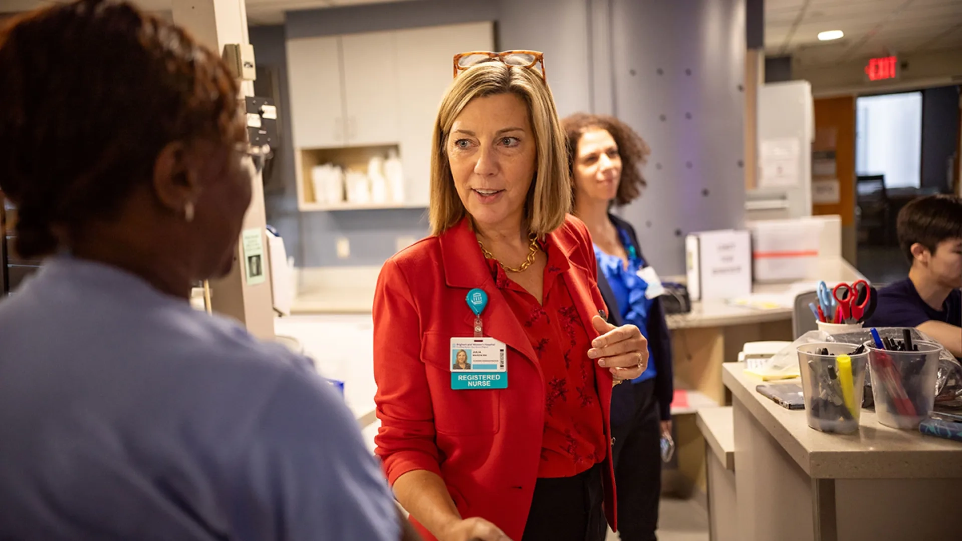 Julia Mason speaks to nurses while in a hospital setting