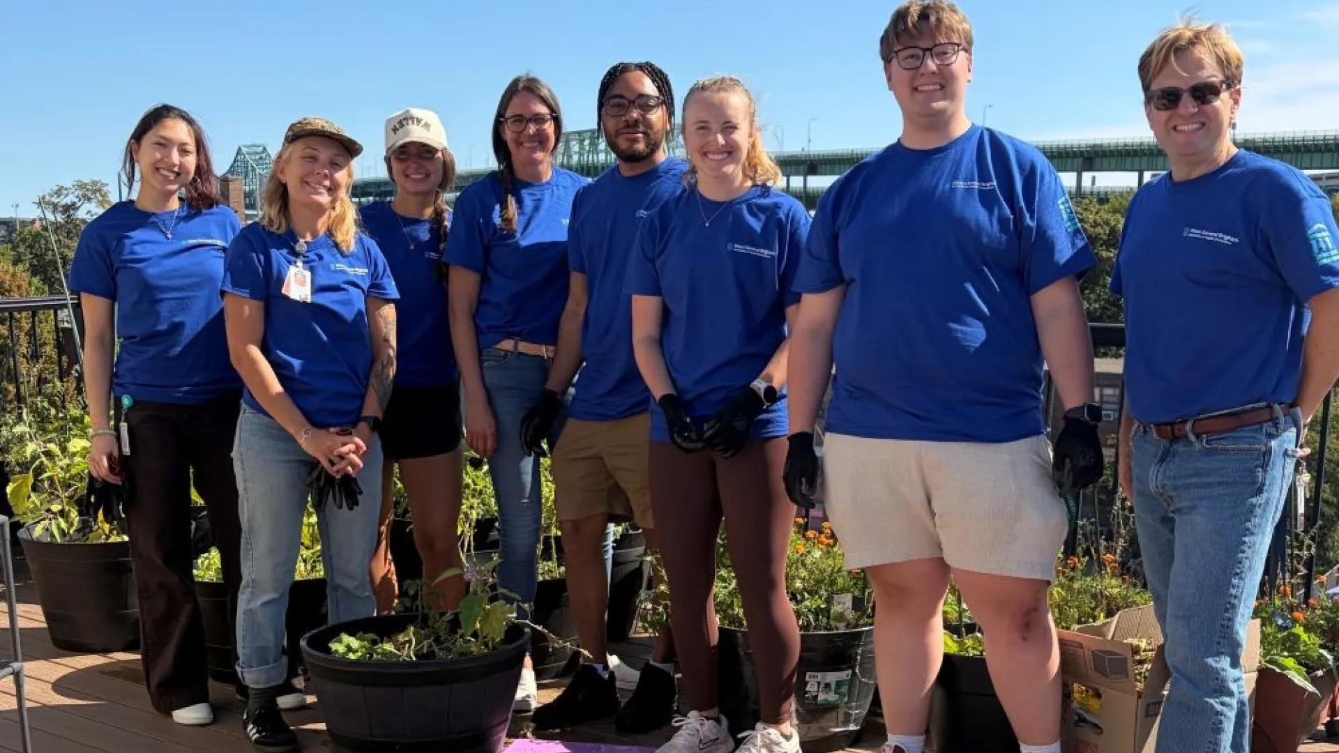 group of people standing together with blue shirts on