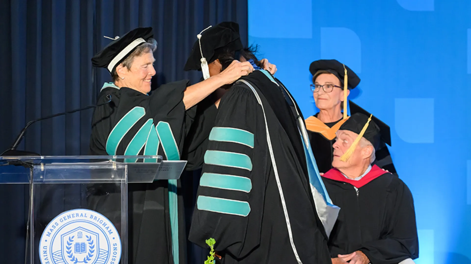 President Emerita Milone-Nuzzo presents President Jones with the University’s medallion