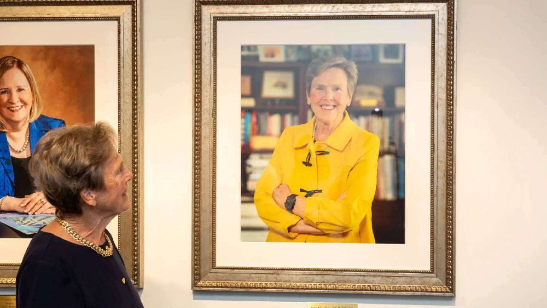 woman looking at portrait of herself
