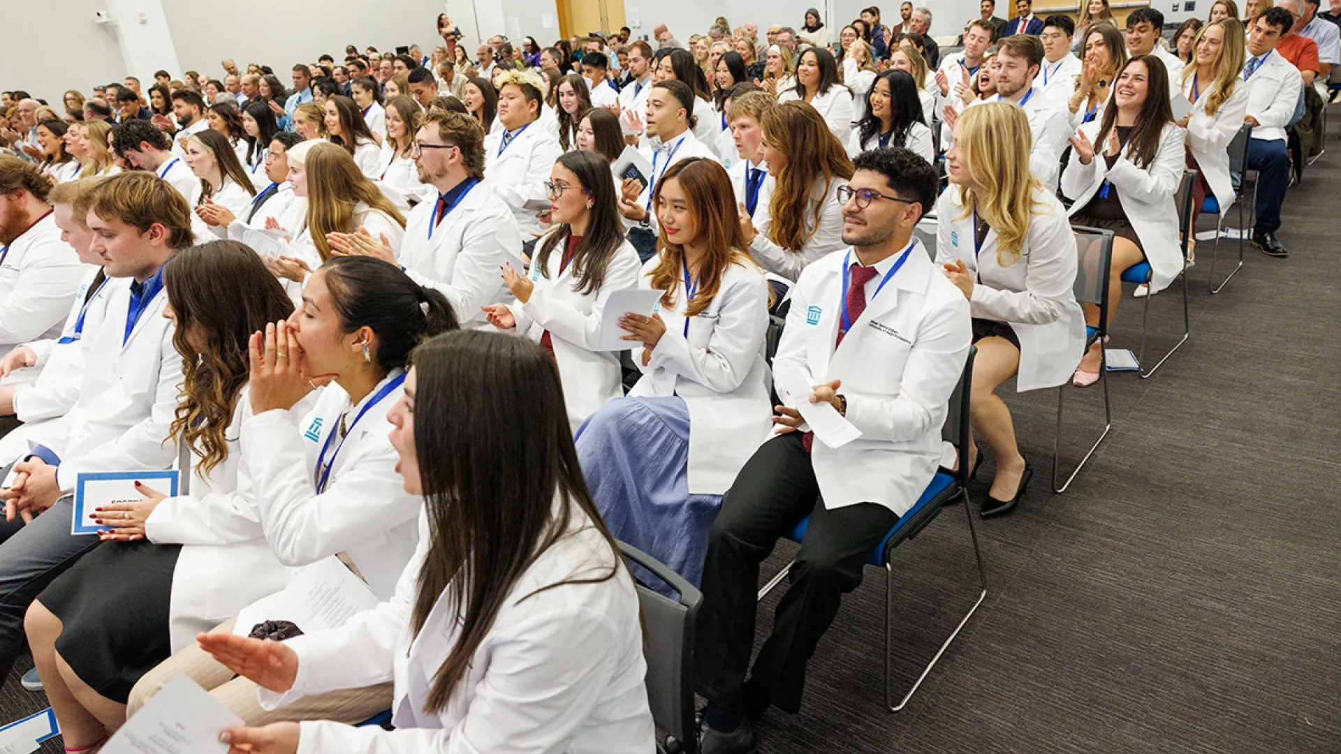 A crowd of physical therapy students at their pinning and white coat ceremony