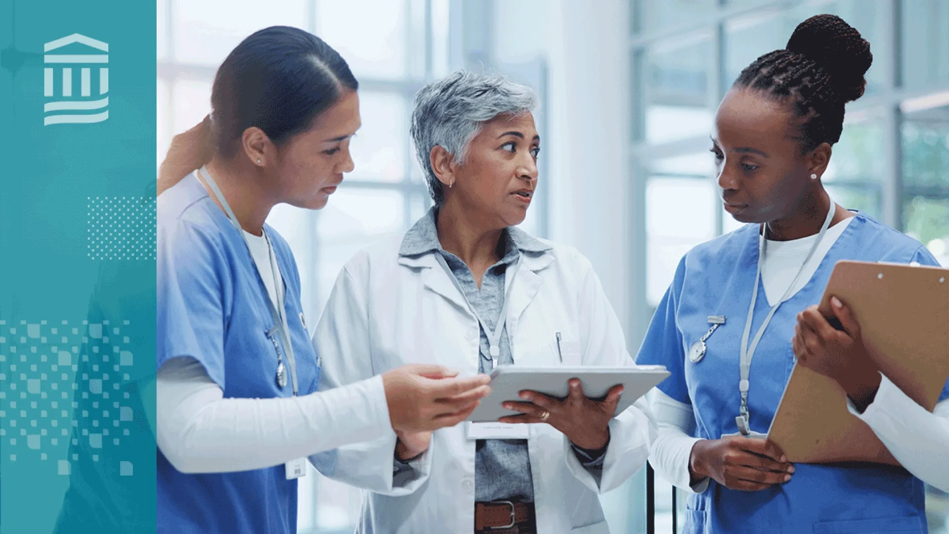 three women healthcare workers in blue and white scrubs holding clipboards