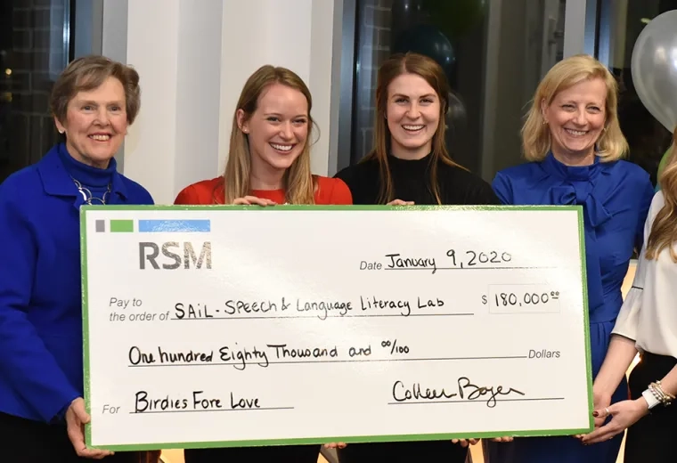Photo of Patrick O’Neill of RSM, IHP President Paula Milone-Nuzzo, IHP students Elise Hopkins Gallegos and Alexandra Hanson, IHP Chief Development Officer Clare McCully, and Erinn Johnson of RSM, holding a large check