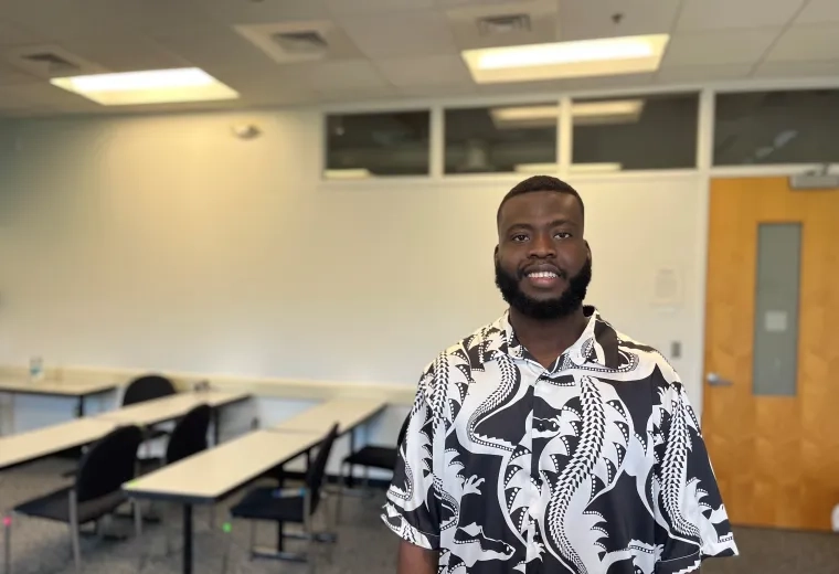 student stands in classroom