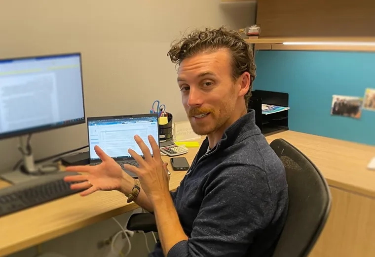 man talks at desk