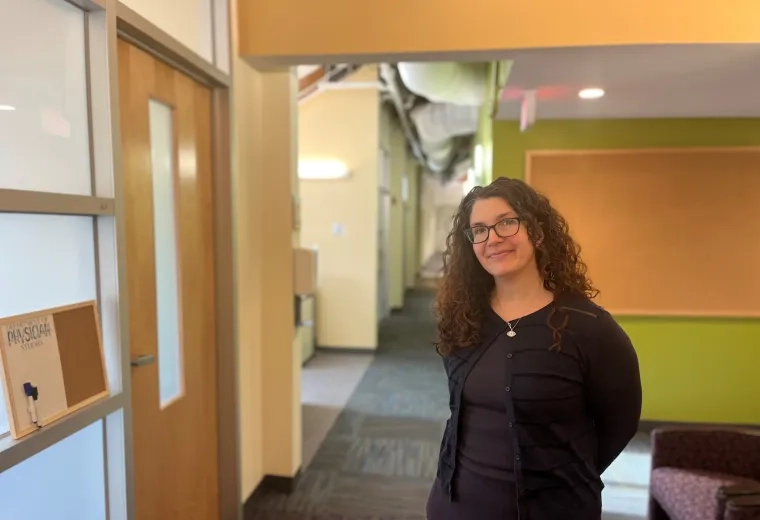woman smiles and poses in hallway