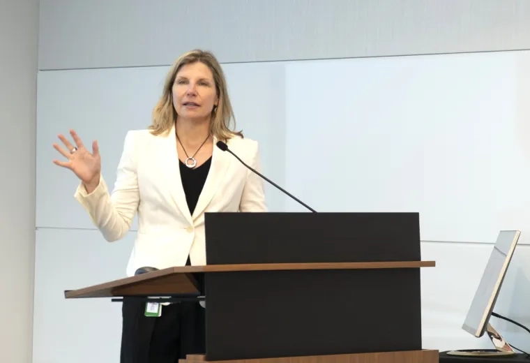 Woman gestures at podium