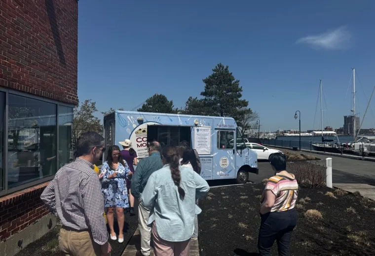 People standing in line in front of food truck