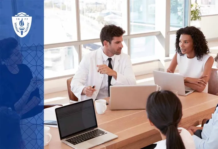 4 people sitting at table with laptops