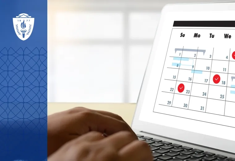 Laptop with a full screen calendar displayed. A person's hands are typing on the keys.