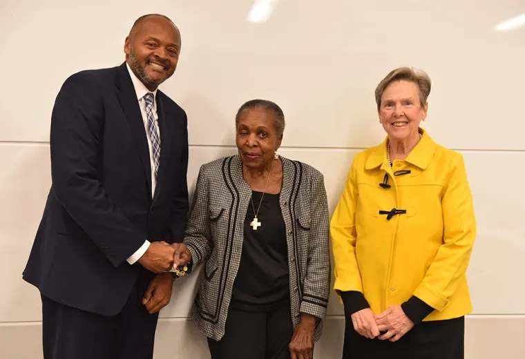 Three people pose for a photo