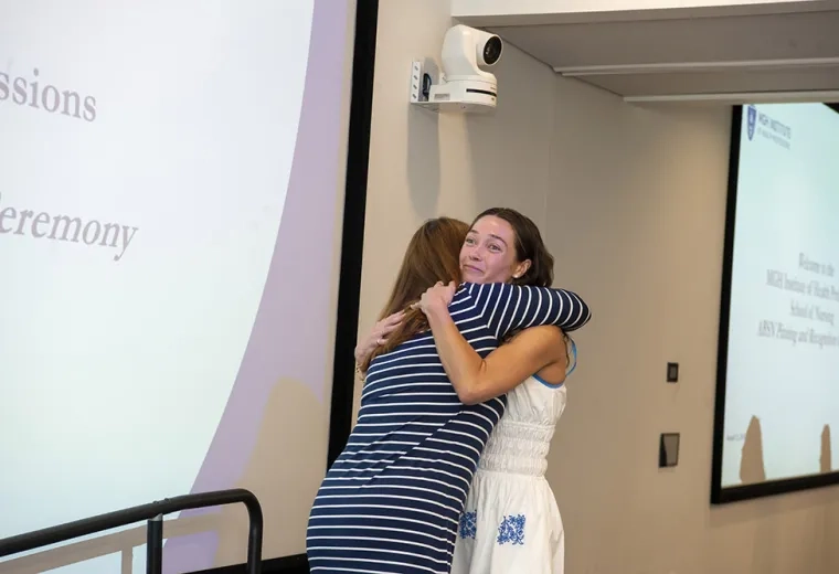 Two women hug 