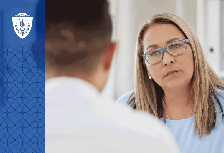 Woman with long blonde hair, glasses, and a blue shirt working with a behavoiral health paraprofessional