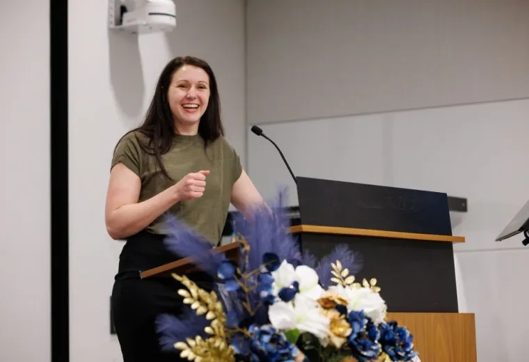 woman in front of a microphone smiling