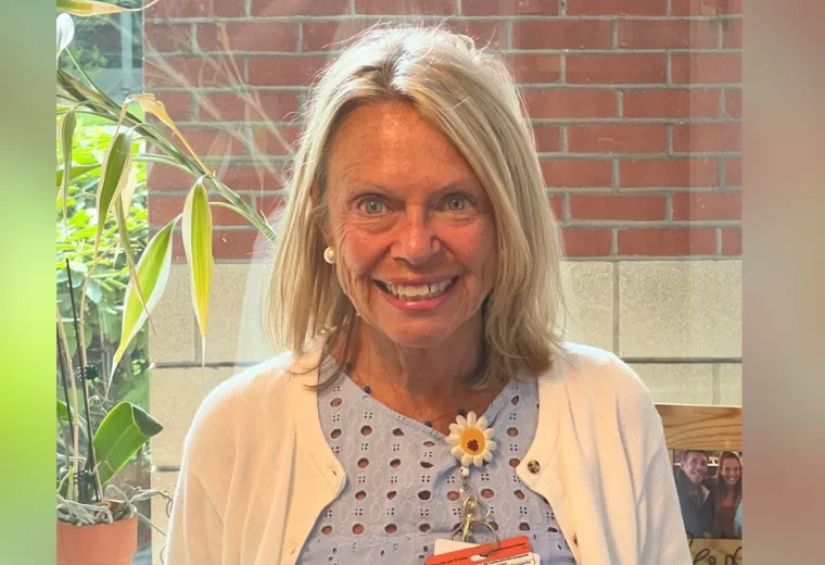 Donna Berizzi stands in front of a brick wall