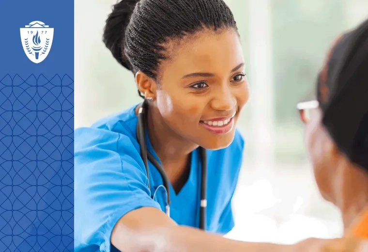 Nurse wearing blue scrubs and a stethoscope around neck putting her hand on shoulder of patient.