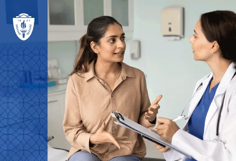 a women's health nurse practitioner goes talks to a patient sitting in an exam room
