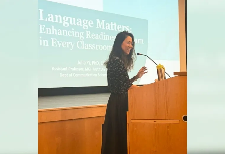 An MGH Institute researcher speaks about literacy at a podium