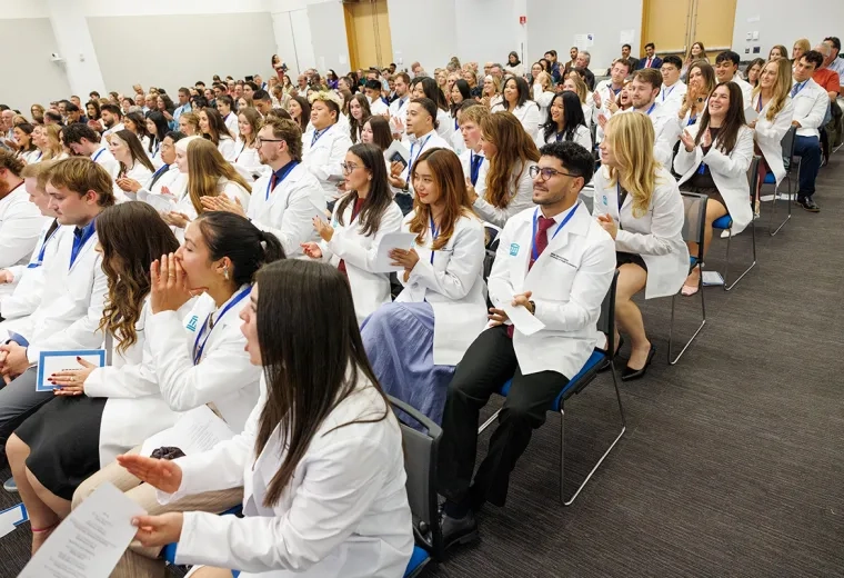 A crowd of physical therapy students at their pinning and white coat ceremony