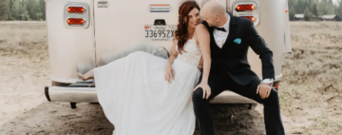 Sylvia Brandenberg and Dan McGuire celebrate their recent marriage at Grant Teton National Park in front of their Airstream trailer.