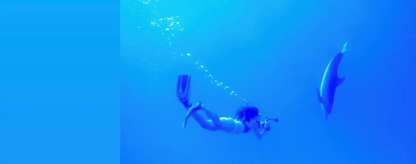 WOMAN DIVES WITH SHARK