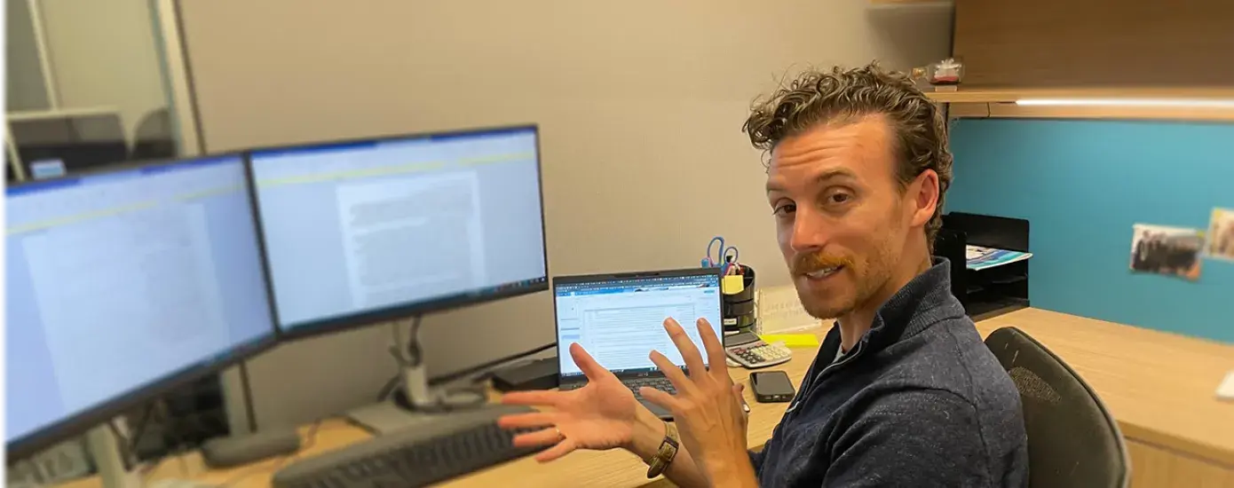 man talks at desk