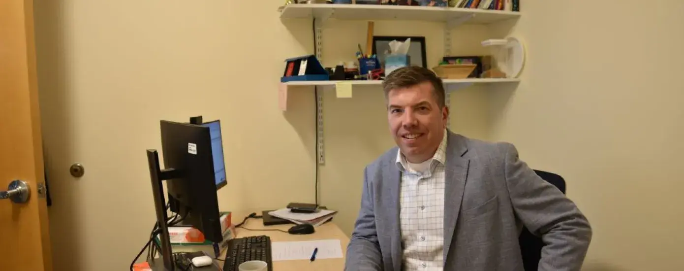 A man sits at a desk