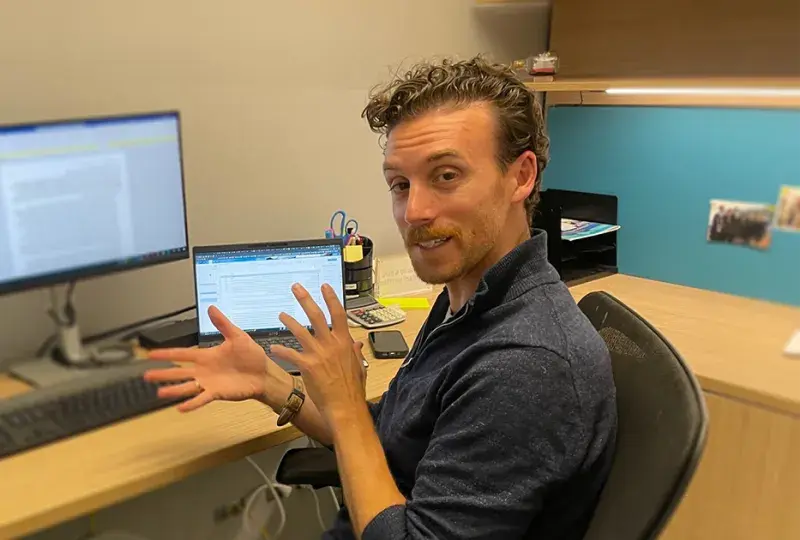 man talks at desk