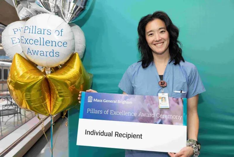 Woman in scrubs smiling