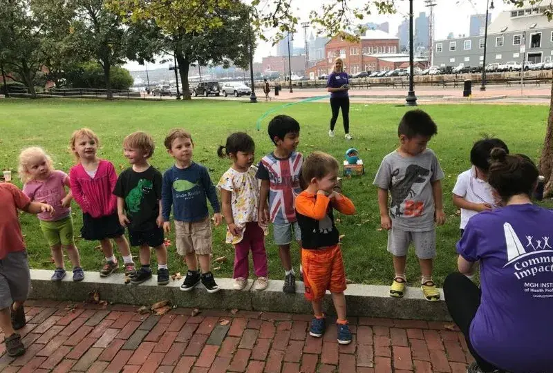 Children wait in a line to receive a medal