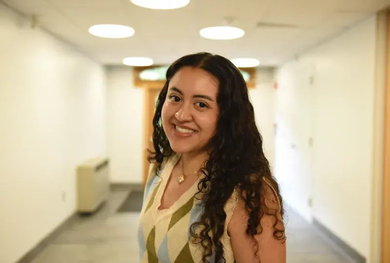 A woman stands in a hallway