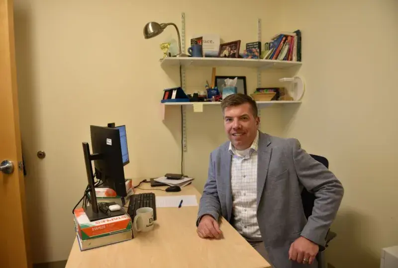 A man sits at a desk