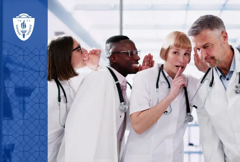people in white lab coats whisper to each other