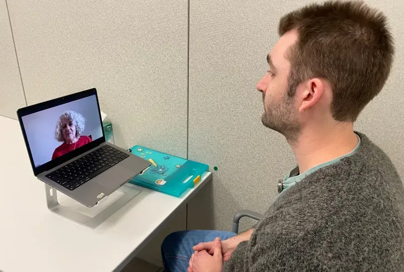 Man talking to woman via computer 