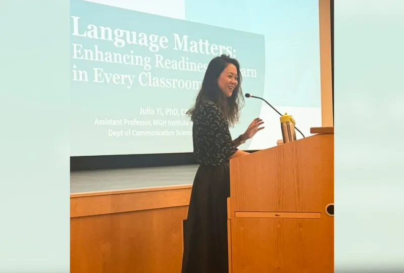 An MGH Institute researcher speaks about literacy at a podium