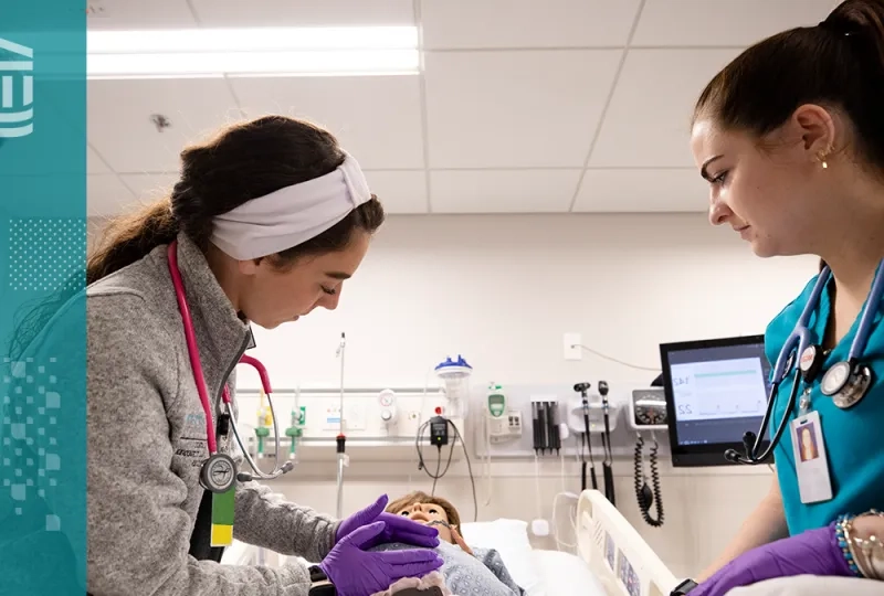 Nursing students at MGH IHP practicing hands-on skills in a simulation lab as part of the ABSN program.