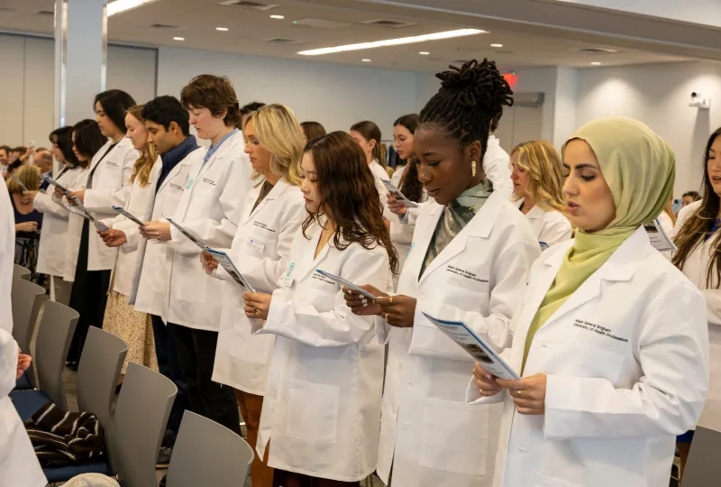 several people standing with white coats