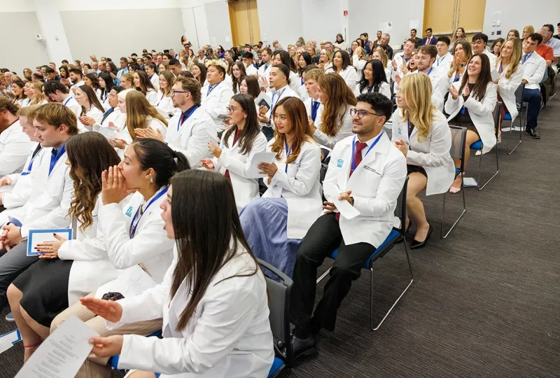 A crowd of physical therapy students at their pinning and white coat ceremony