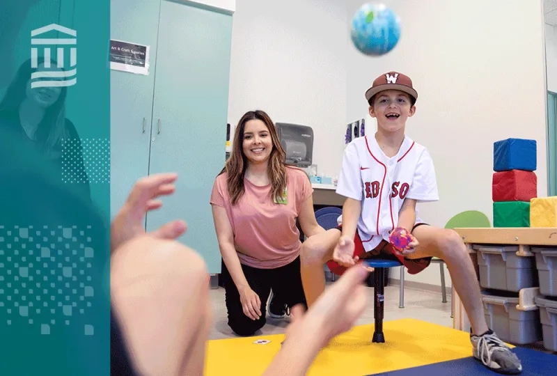 a boy throws a ball showing what occupational therapists do in a therapy setting
