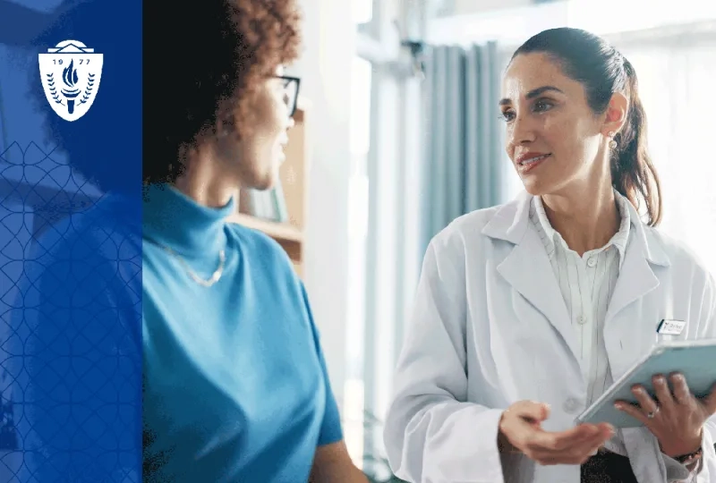 Physical therapy student speaking with a patient in a community clinic setting  A physical therapy student sits at eye level with a patient during a conversation about care goals, emphasizing communication, empathy, and patient-centered care. 