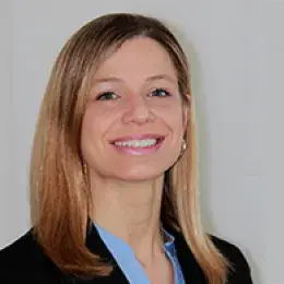 Professional headshot of a Doctor of Occupational Therapy program faculty member with blonde hair, wearing a light blue shirt and black blazer