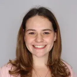 Alyson Pollard in pink sweater and black shirt