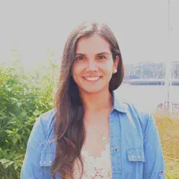 Nadine Alejandra Aranis Seguic has long brown hair and is wearing a blue denim jacket and white lace shirt