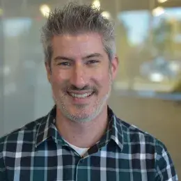 kevin has a blue plaid flannel shirt