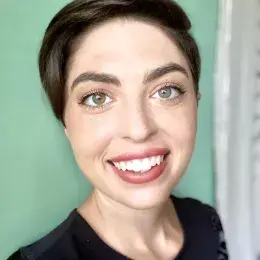 alex morton in front of a green wall