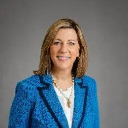 Photo of Julia Mason smiling and looking at the camera wearing a blue jacket