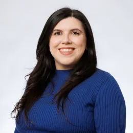 A woman wearing a blue sweater