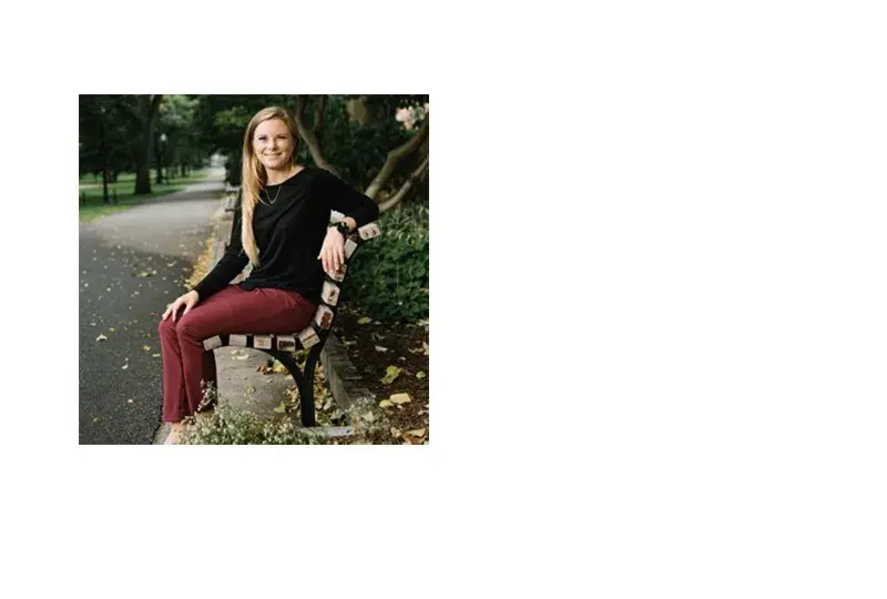 lauren sits on a park bench and has long blonde hair