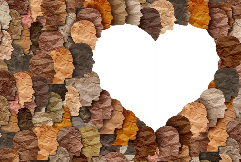 heart in white with brown paper faces around it